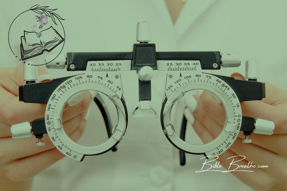 Crop anonymous female optometrist wearing medical robe holding modern trial frame with lenses in hands in modern optometry clinic