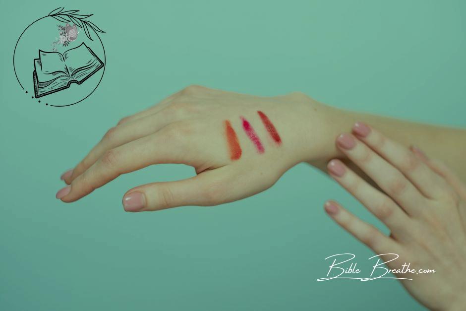Persons Hand With Different Shades Of Lipstick
