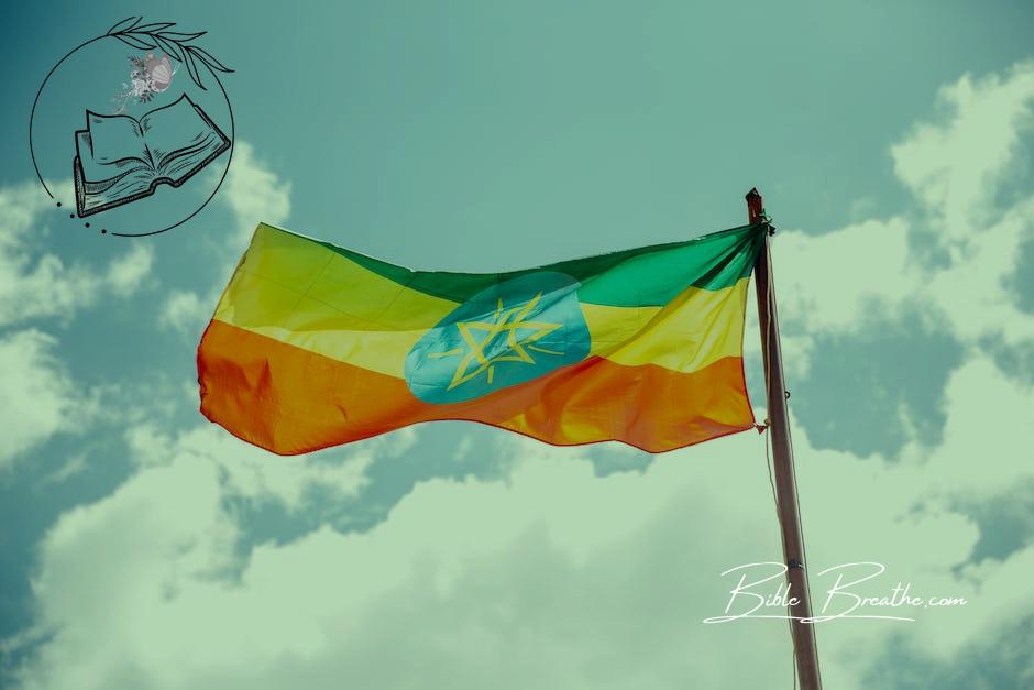 National colorful flag of Ethiopia under cloudy sky