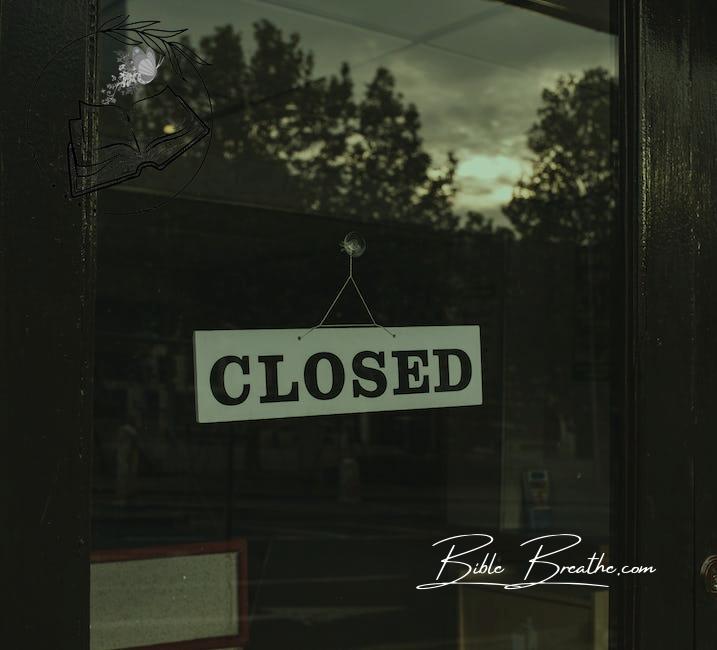 Closed sign on shop glass door