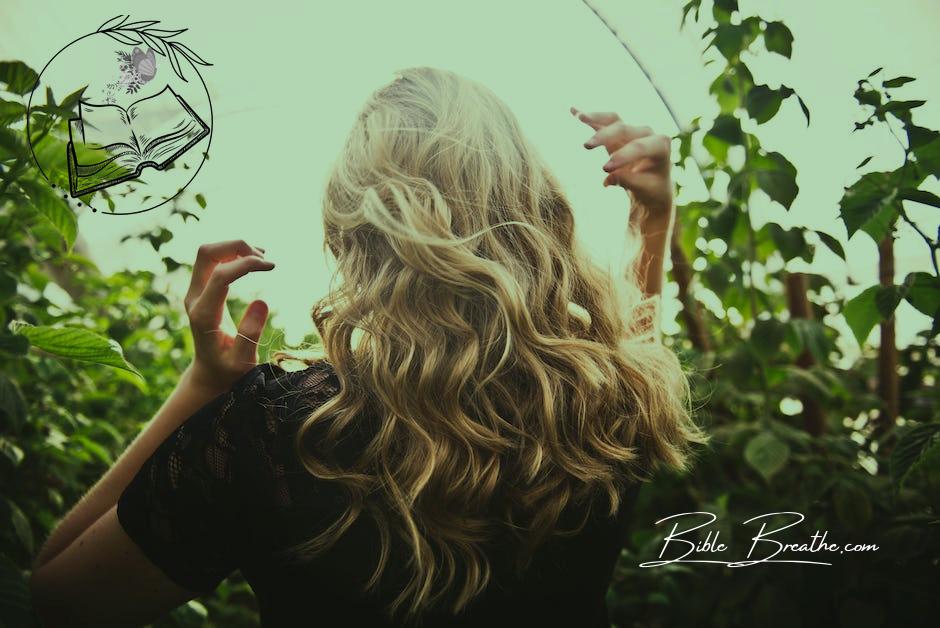 Blonde-haired Woman Standing Between Green Plants