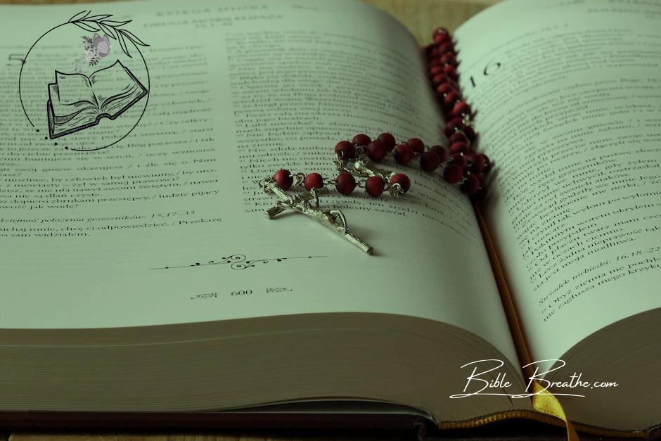 Rosary on Top of Opened Bible Book