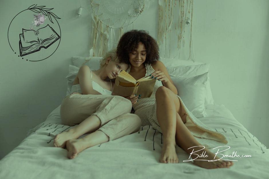 A Same Sex Couple Reading a Book while Lying on the Bed