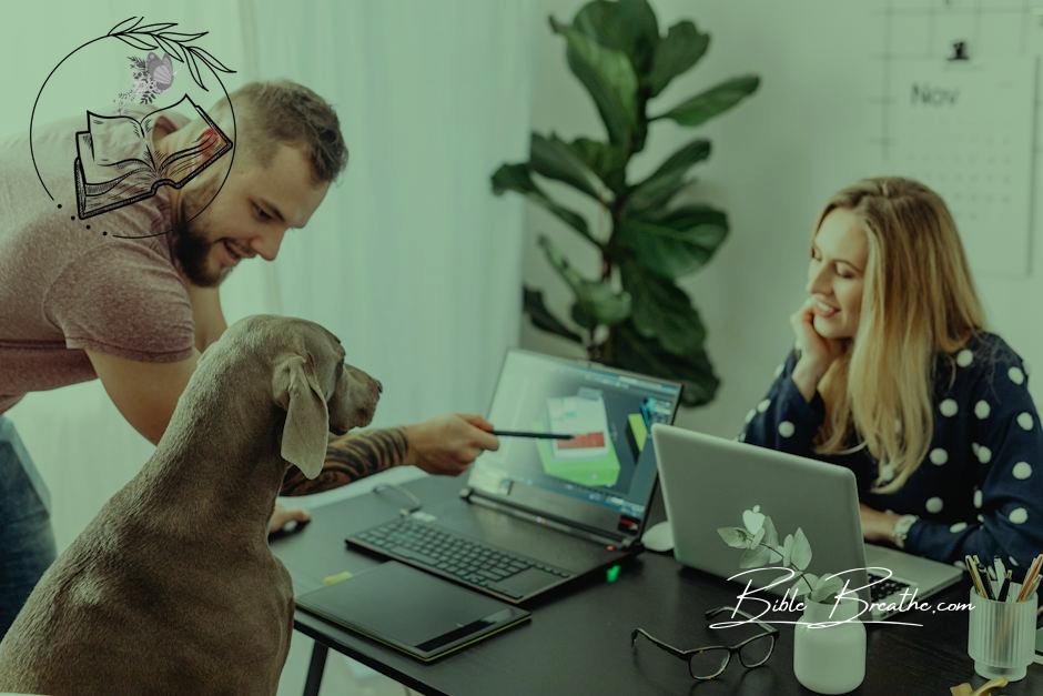 Woman and a Man Presenting Image on a Laptop Screen to a Dog