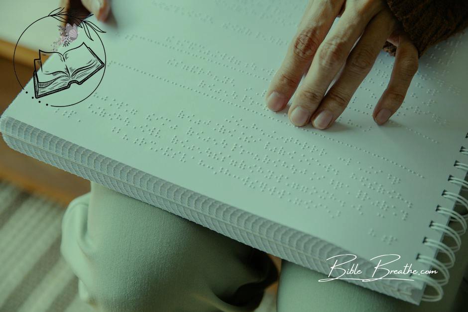 Photo of Person Holding White Braille Paper