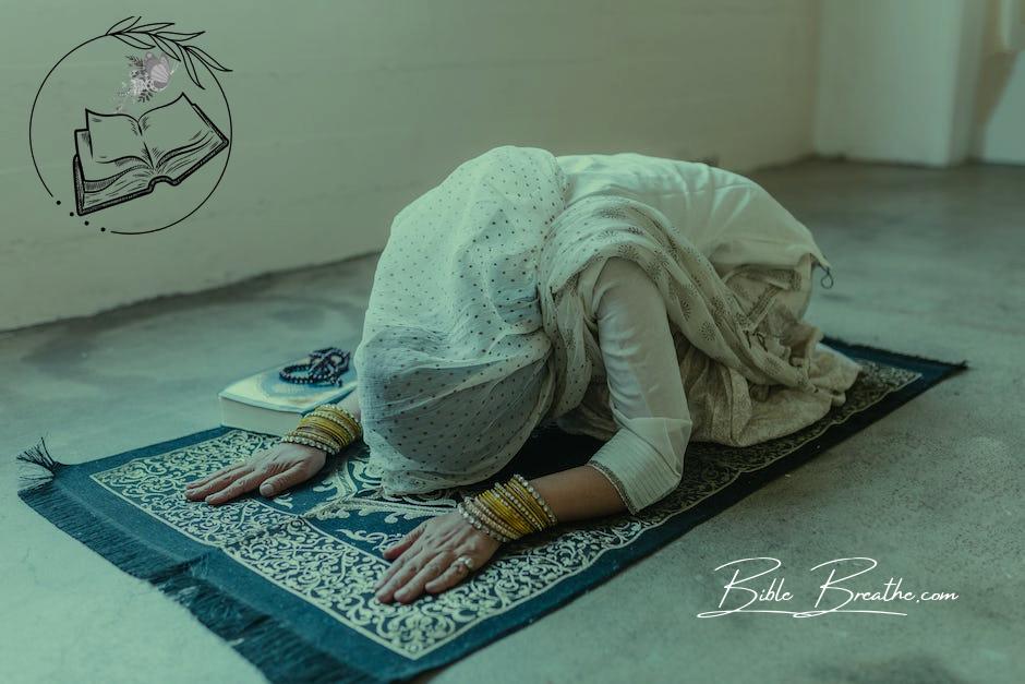 A Woman Wearing a White Headscarf Bowing Down on a Prayer Rug
