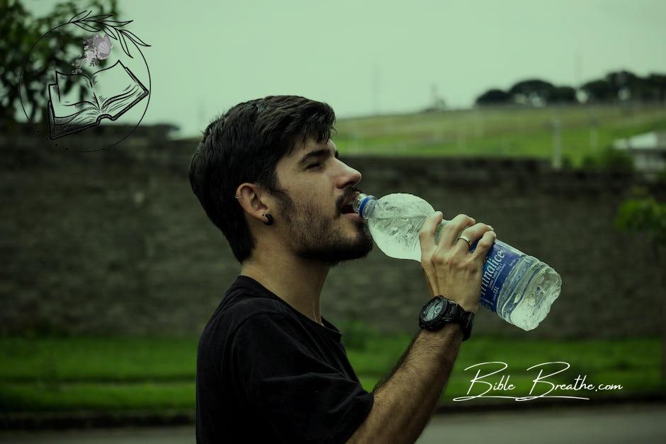 Man Wearing Black Shirt Drinking Water