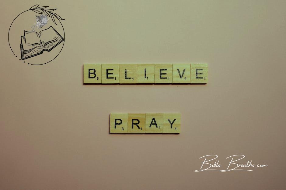 A Believe and Pray Words of Encouragement  on Pink Surface