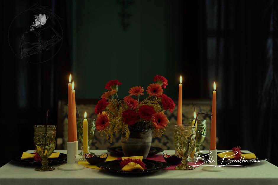 Table Setting With Lighted Candles and Flowers
