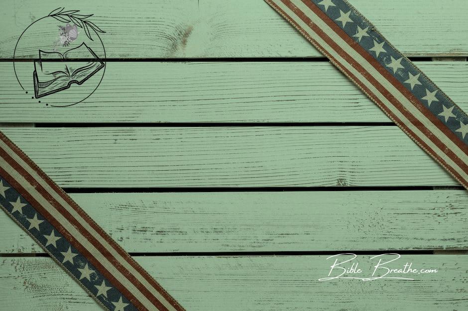 From above of similar ornamental ribbons with stripes and stars representing   patriotism on wooden surface