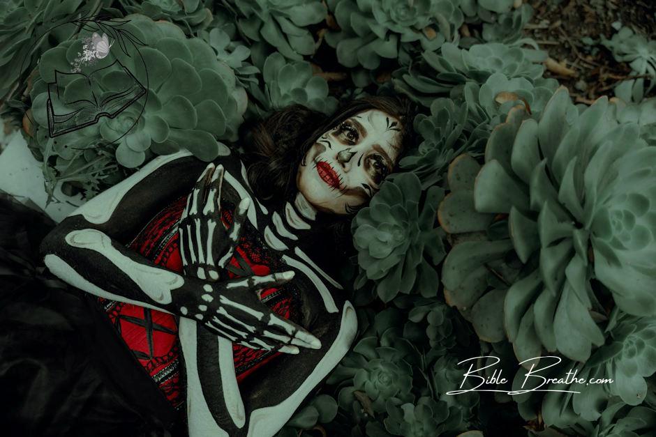 Woman Wearing Halloween Costume Lying Among Plants 