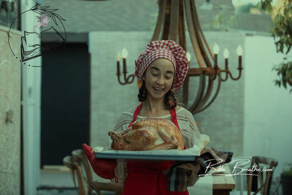 Woman with Chefs Hat Holding Tray with Roasted Turkey
