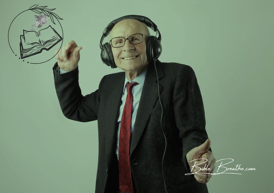 Cheerful elderly man listening to music in headphones