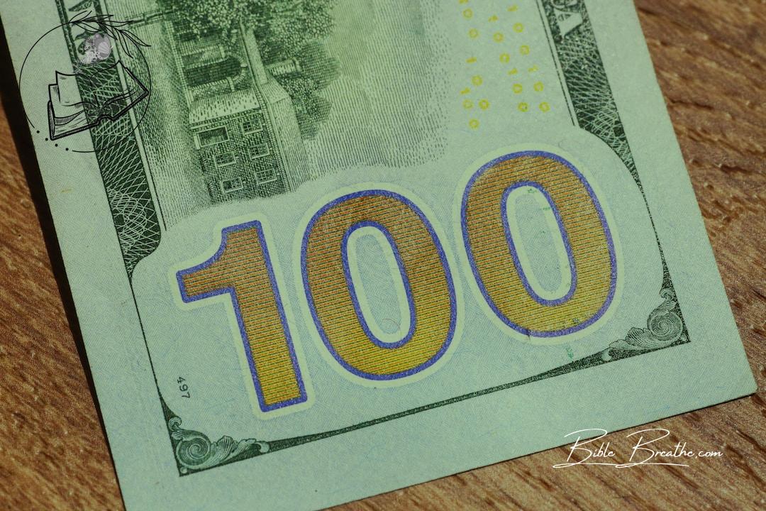 a hundred dollar bill with the number 100 on it