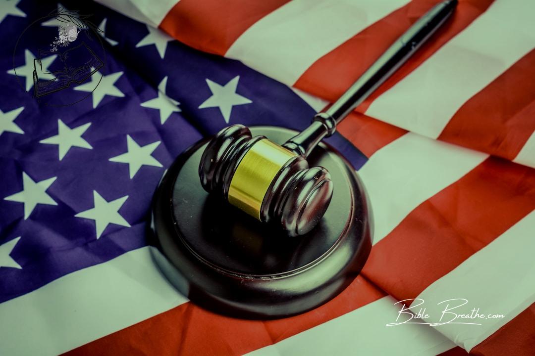 a judge's gavel on top of a flag