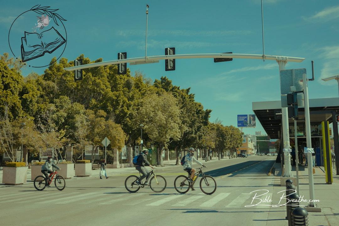 a group of people riding bikes across a street