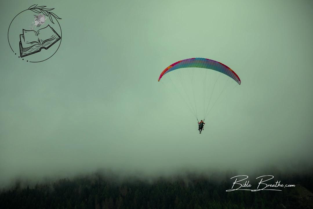 a person is parasailing on a cloudy day