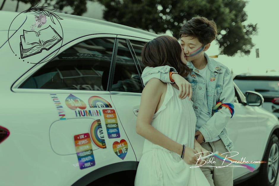 Two Lesbian Women Kissing Each Other Standing at Car with Rainbow Labels 