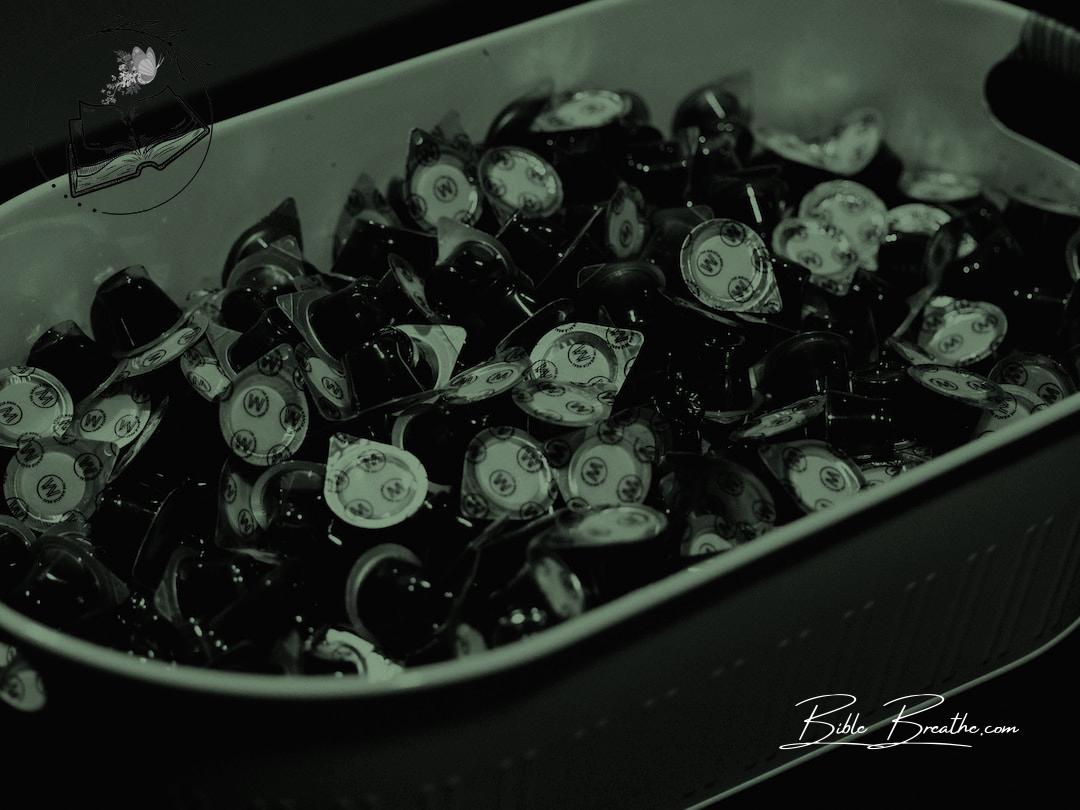 a container filled with lots of black and white candies