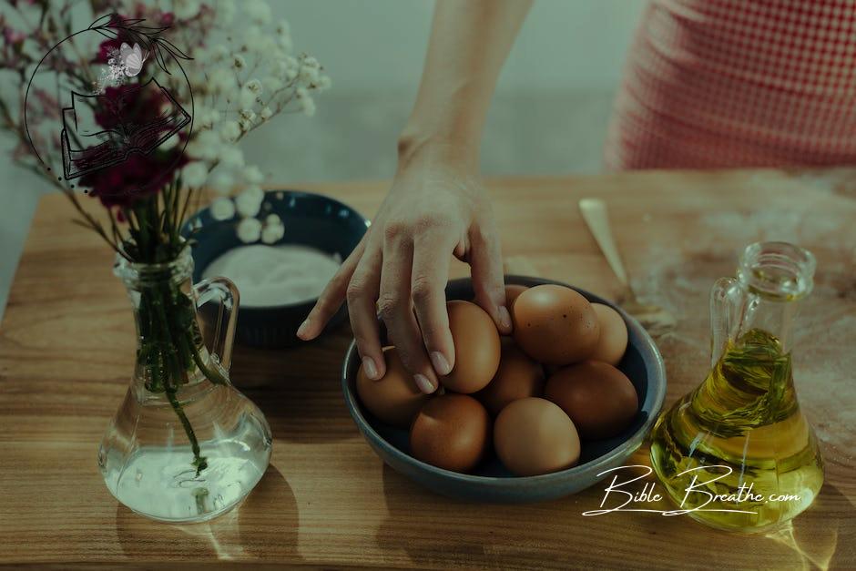 Unrecognizable Female Hand Choosing Egg from Bowl