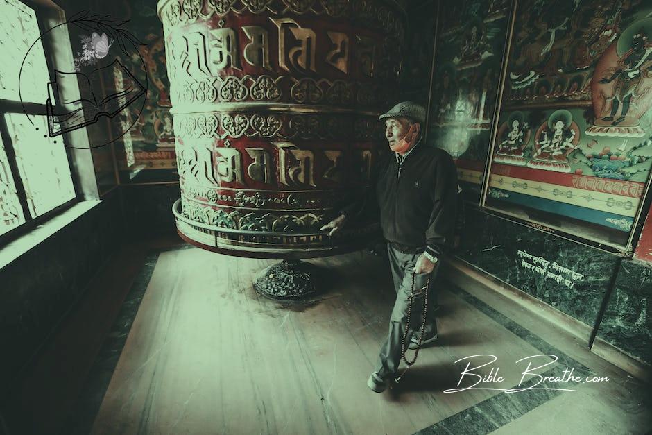 Full body contemplative elderly Asian male wearing casual outfits walking around prayer wheel in authentic religious temple