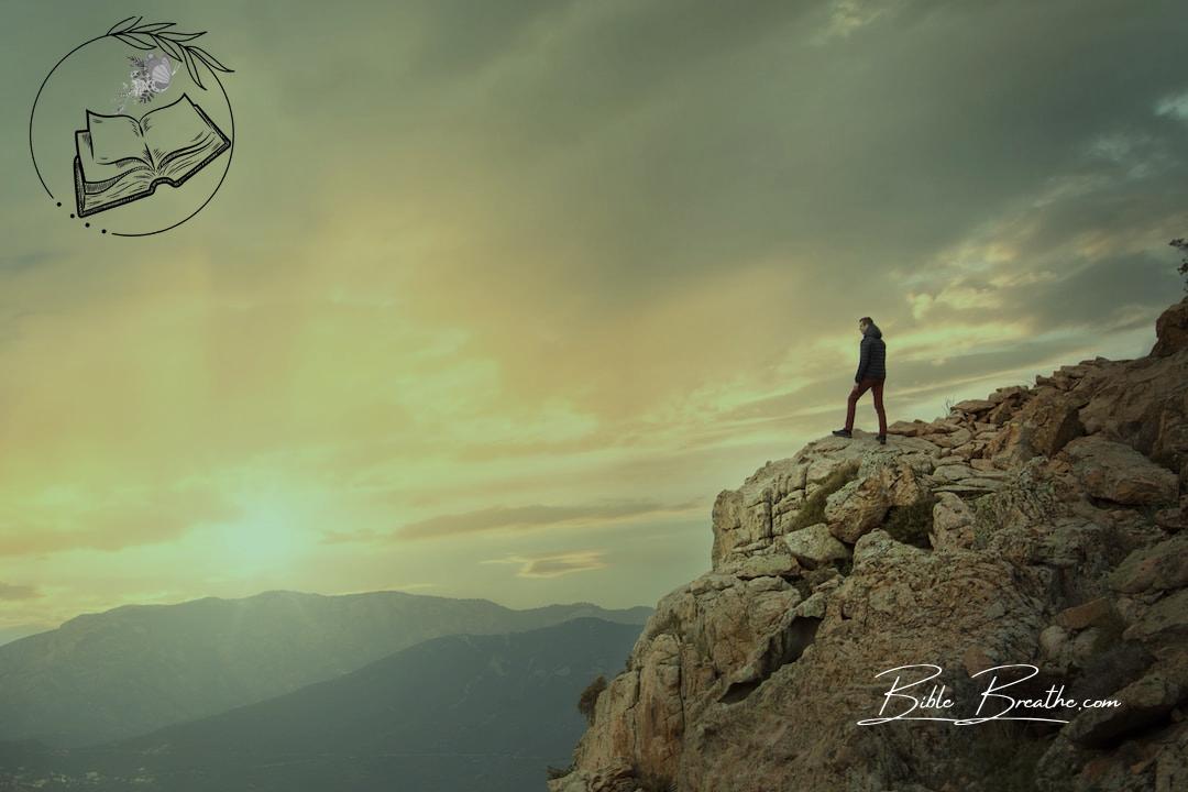 a person standing on a rocky hill