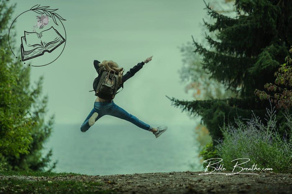 Woman Jumping Wearing Green Backpack