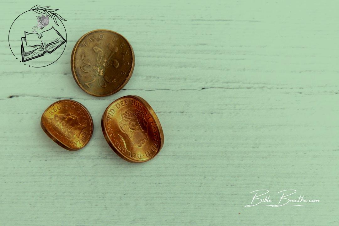 2 silver round coins on white wooden table