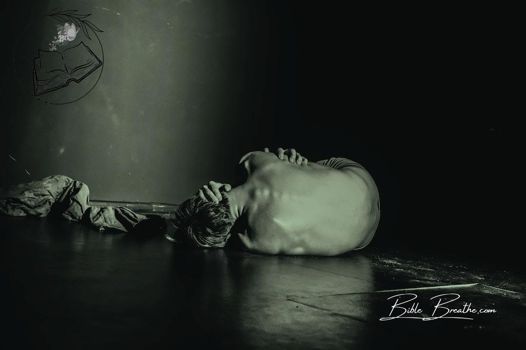 grayscale photography of man lying on floor