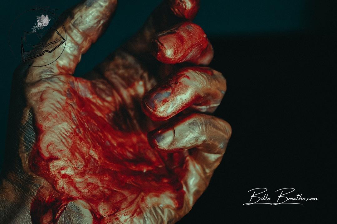 a person's hand with blood on it