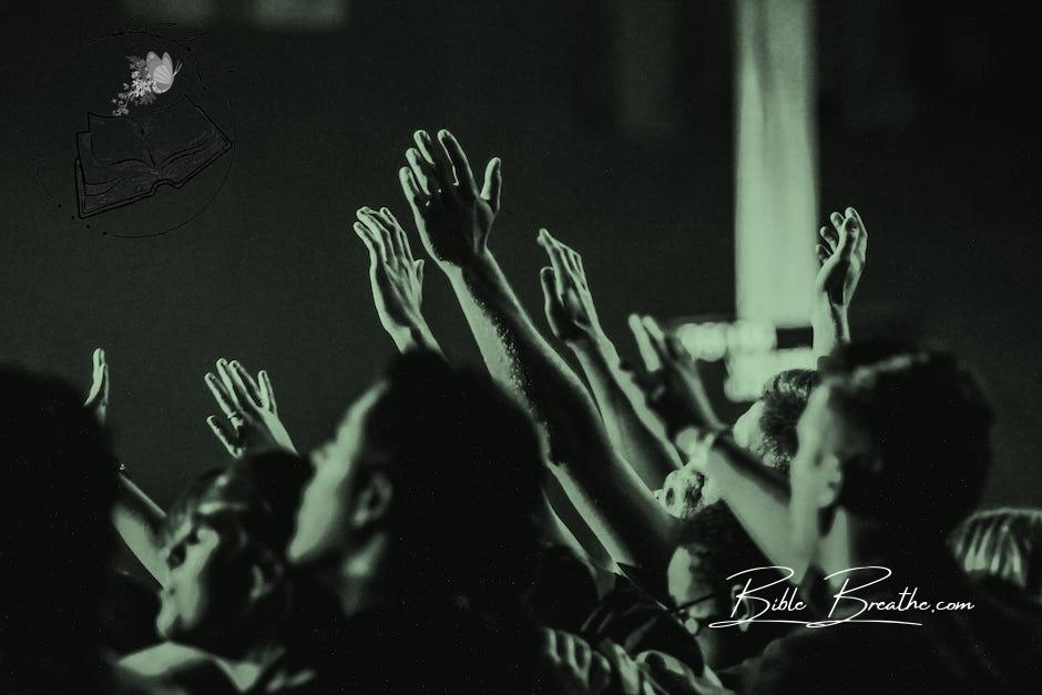 Grayscale Photo of People Raising Their Hands