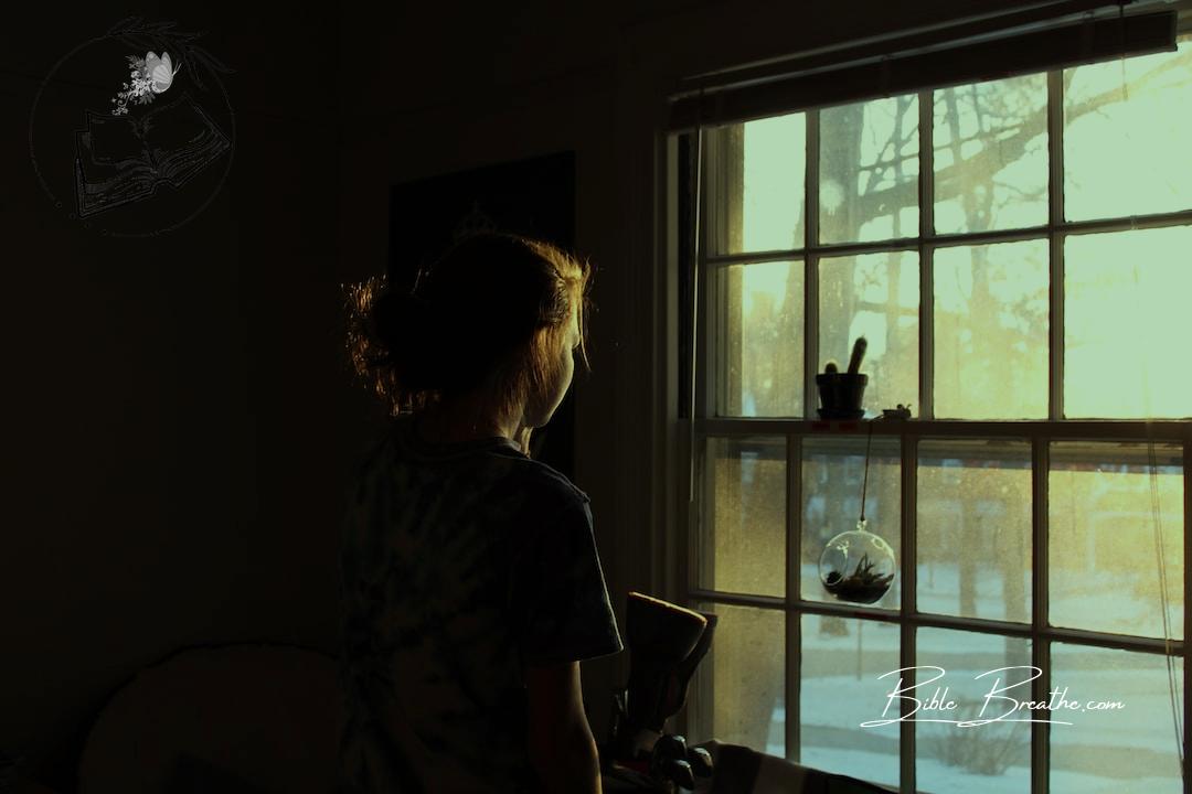 woman in room facing window