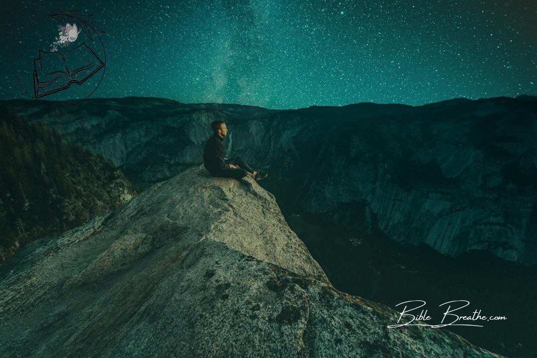 person sitting on mountain