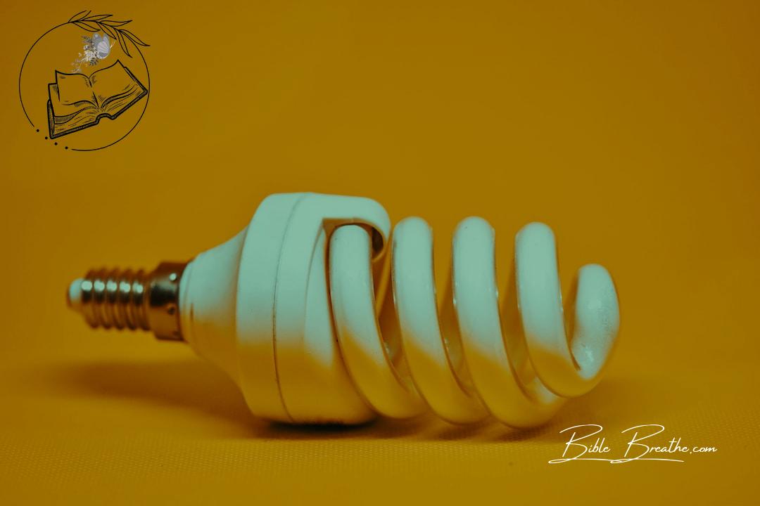 white spiral light bulb on yellow surface