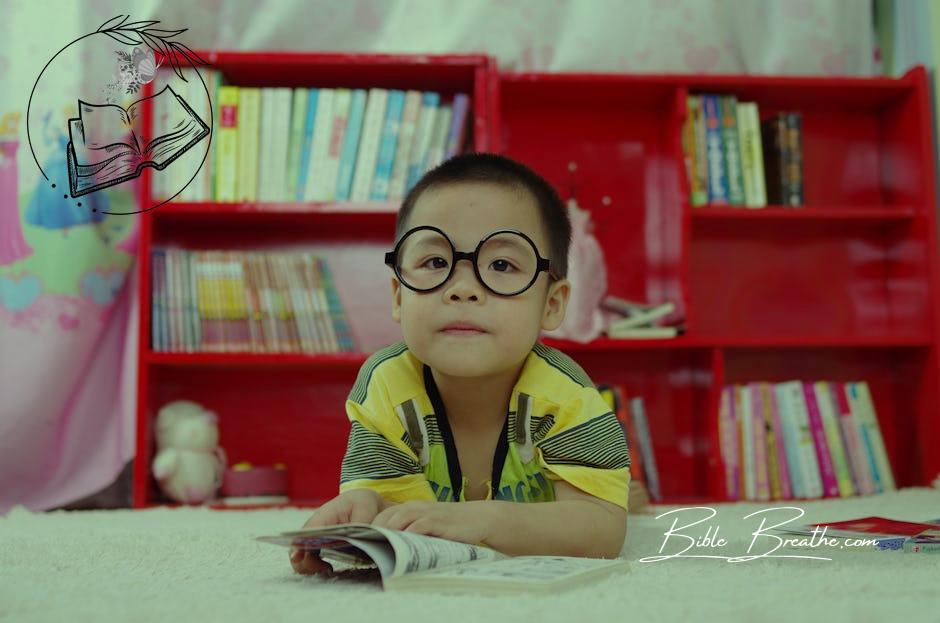 Boy Standing Near Bookshelf