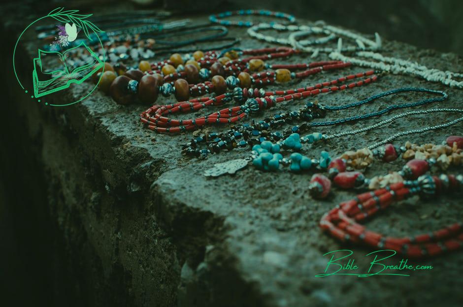 Close Up Photo of Beaded Accessories on Gray Surface