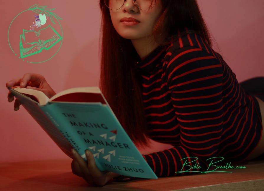 Woman in Striped Long Sleeve Shirt Holding a Book